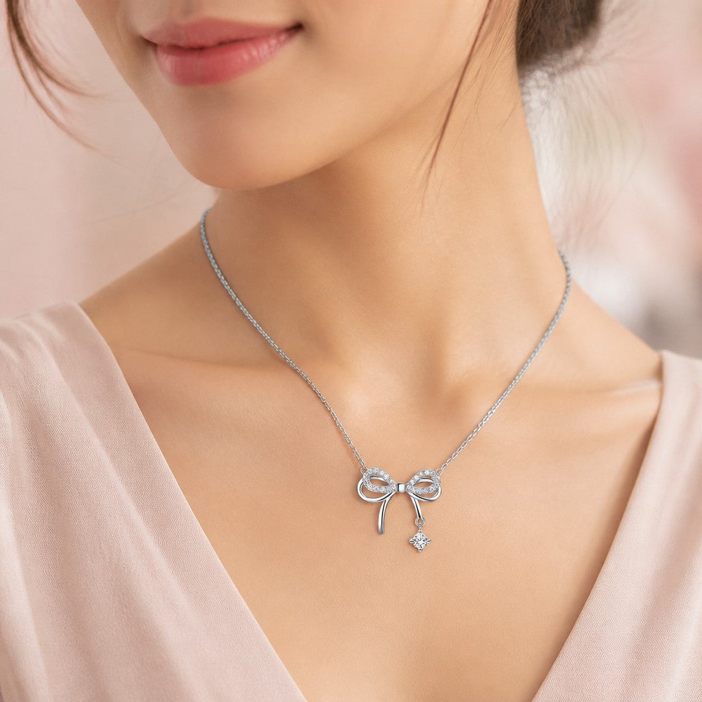 Shiny Silver Bow Necklace — on model